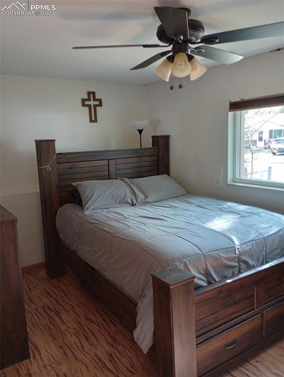 bedroom with hardwood / wood-style floors and ceiling fan