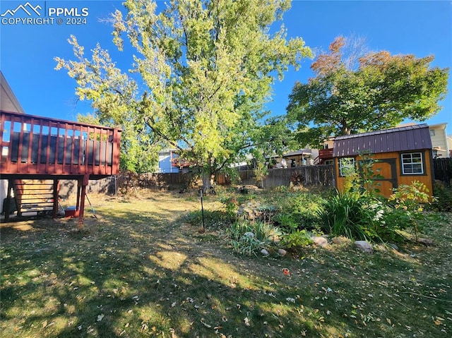 view of yard with a storage shed and a wooden deck