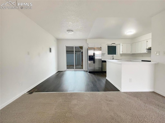 kitchen featuring dark wood-type flooring, sink, white cabinetry, and stainless steel fridge with ice dispenser