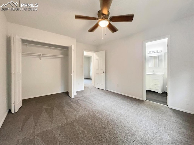 unfurnished bedroom with a closet, ceiling fan, dark carpet, and connected bathroom