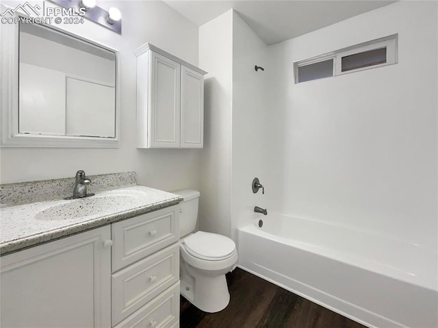 full bathroom featuring wood-type flooring, vanity, toilet, and bathing tub / shower combination