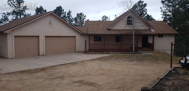 view of front of home featuring a porch and a garage