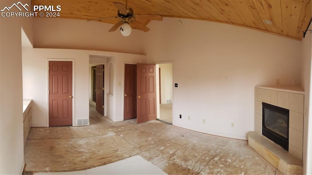 unfurnished living room featuring a tile fireplace, high vaulted ceiling, ceiling fan, and wood ceiling