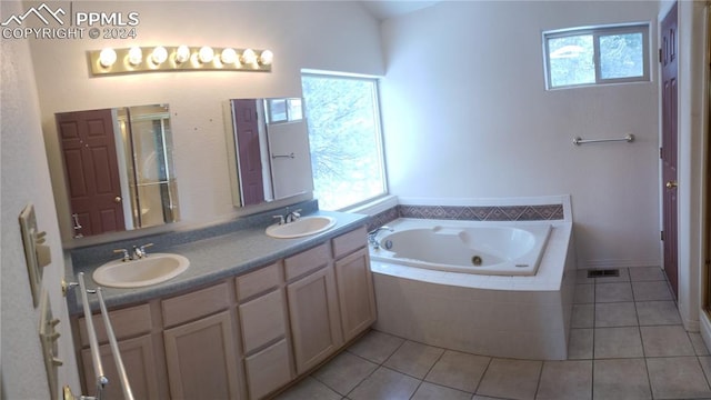 bathroom with tile patterned flooring, plenty of natural light, and vanity