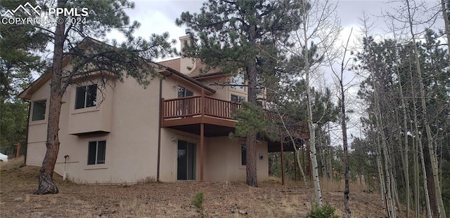 rear view of property with a balcony