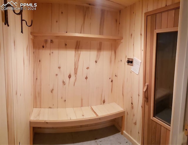 mudroom featuring wooden walls