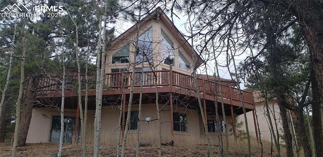 back of house featuring a deck