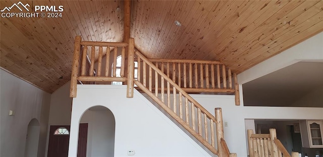 stairway featuring beam ceiling, high vaulted ceiling, and wooden ceiling