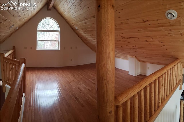 additional living space featuring vaulted ceiling with beams, wood ceiling, and hardwood / wood-style flooring