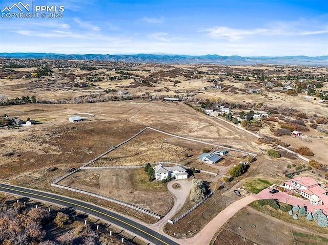 birds eye view of property featuring a mountain view