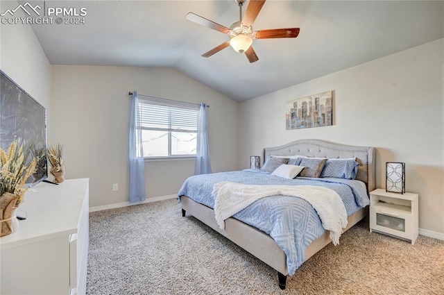 carpeted bedroom with ceiling fan and vaulted ceiling