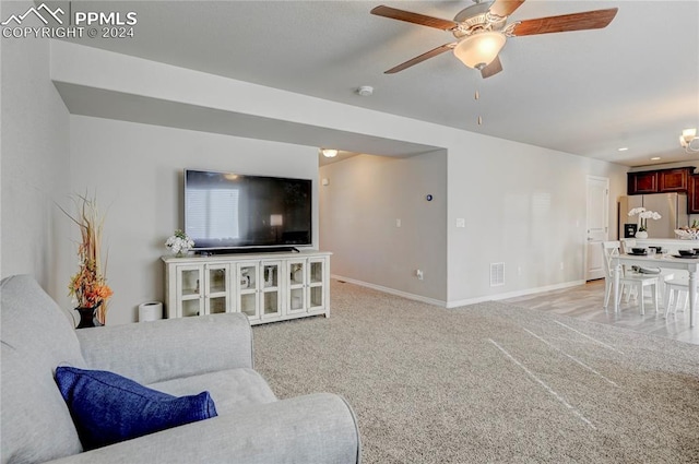 living room featuring ceiling fan and light carpet