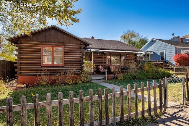 log-style house featuring a front lawn