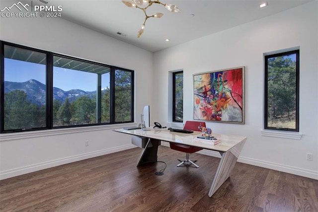 office featuring dark wood-style floors, visible vents, baseboards, and an inviting chandelier