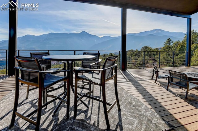 exterior space with a mountain view and outdoor dining space