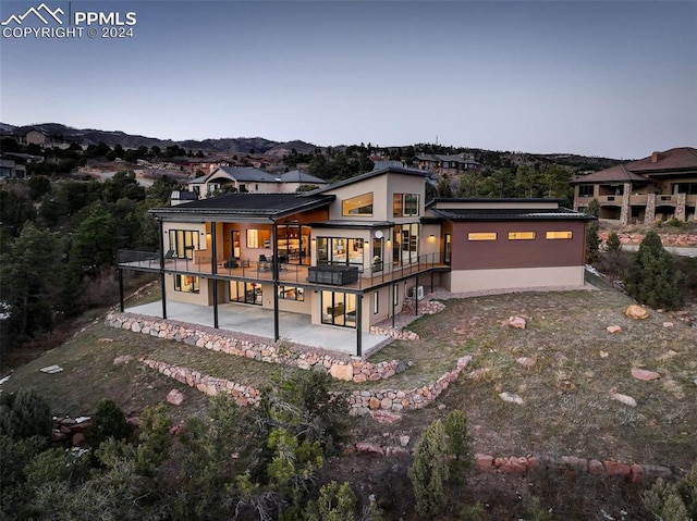 rear view of property with a patio area and stucco siding