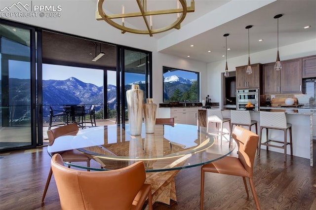 dining space featuring dark wood-style flooring, a mountain view, and recessed lighting