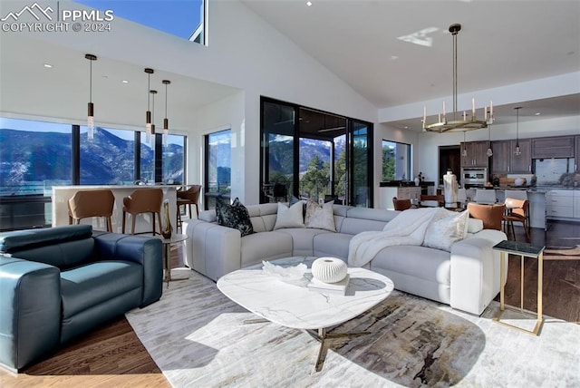 living area with wood finished floors and a towering ceiling