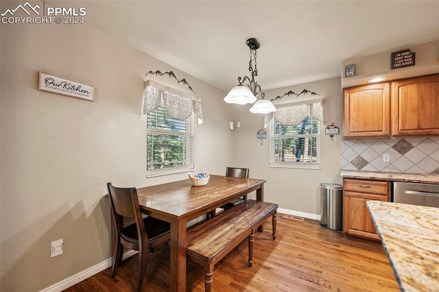 dining space with light wood-type flooring and a healthy amount of sunlight