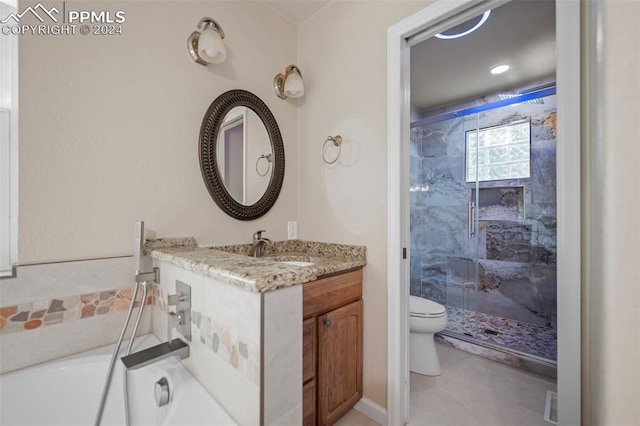 bathroom featuring vanity, toilet, and a tile shower