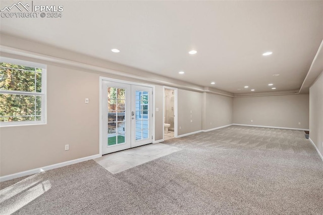 carpeted spare room with french doors