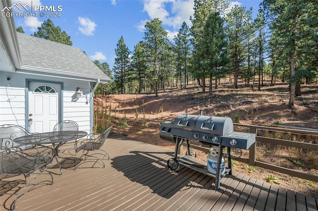 wooden terrace with a grill