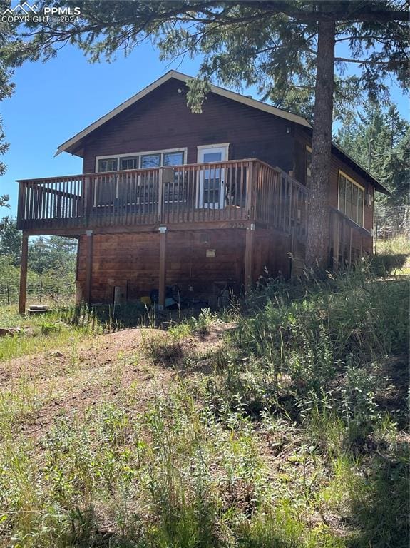 back of house featuring a wooden deck