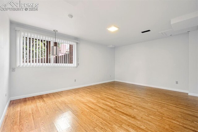 empty room with wood-type flooring