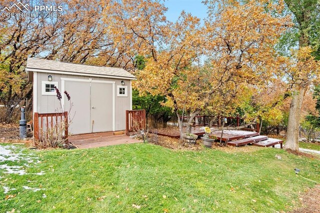 view of yard featuring a shed and a wooden deck