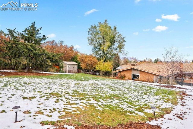 snowy yard with a storage unit