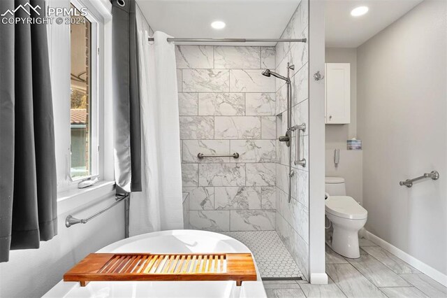 bathroom with a shower with shower curtain and toilet