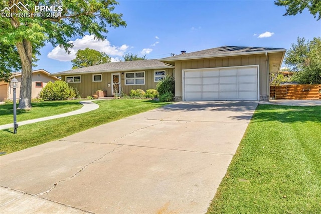 ranch-style home with a garage and a front yard