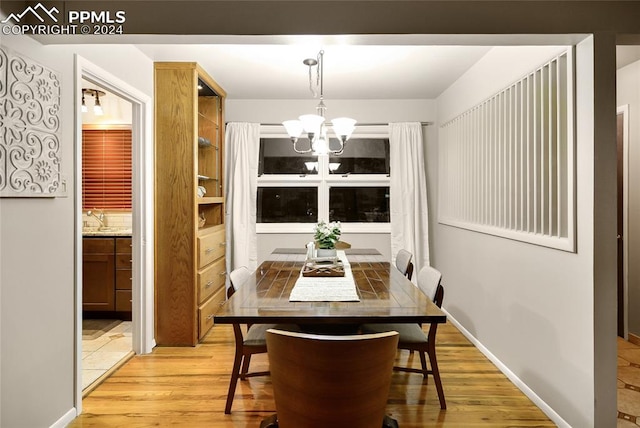 dining room featuring an inviting chandelier and light wood-type flooring