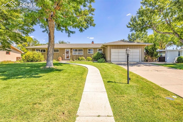 ranch-style home with a garage and a front yard