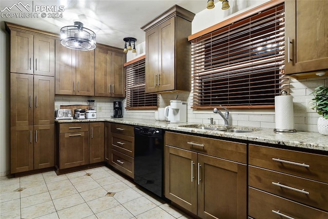 kitchen with light stone countertops, sink, dishwasher, and tasteful backsplash