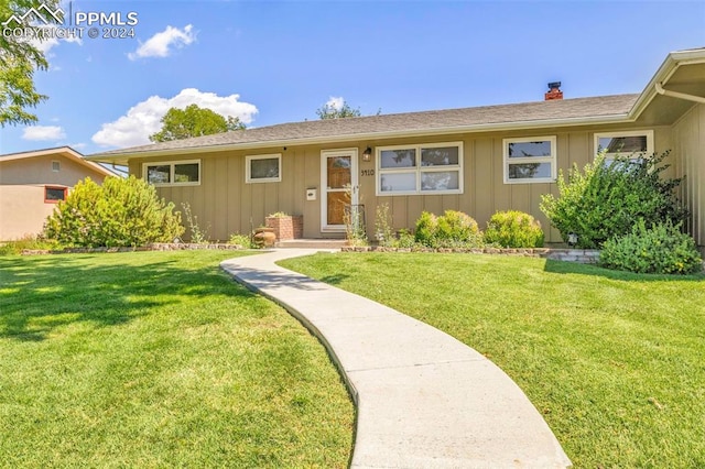 ranch-style house with a front lawn