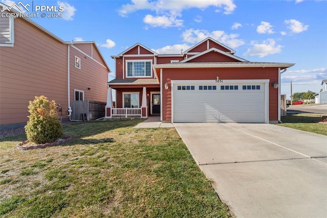 view of front of house with a front lawn and a garage