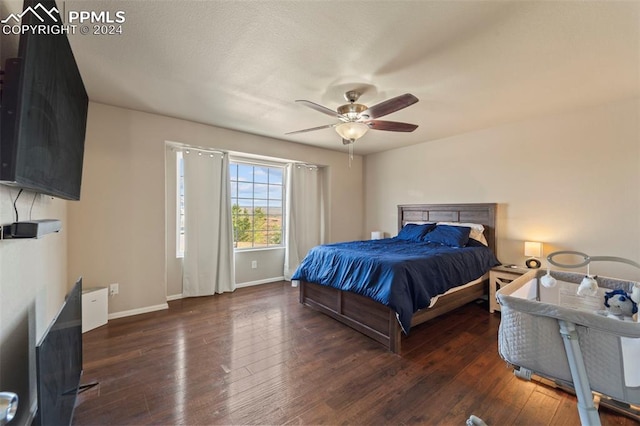 bedroom featuring dark hardwood / wood-style flooring and ceiling fan