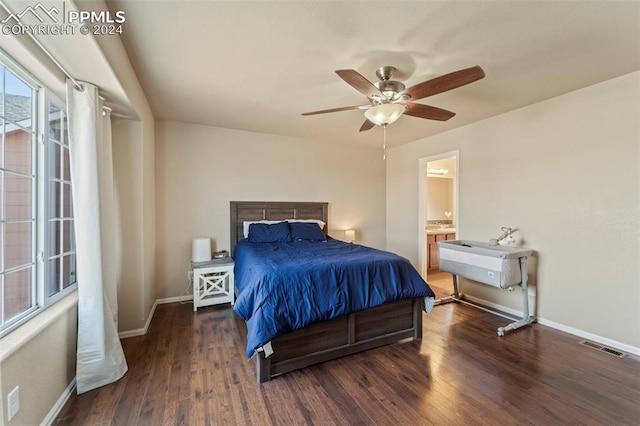 bedroom with dark hardwood / wood-style floors, ceiling fan, and connected bathroom