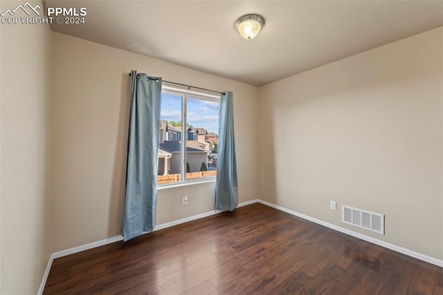 empty room with dark hardwood / wood-style floors