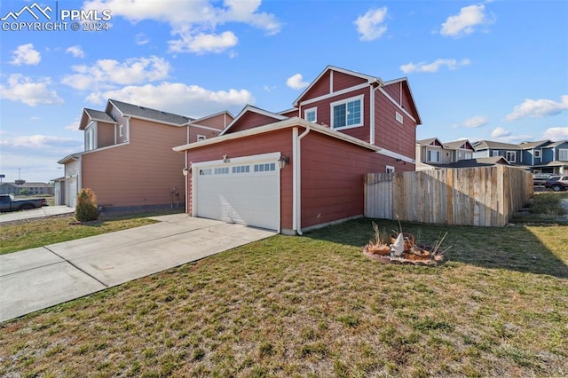 view of side of property featuring a garage and a yard