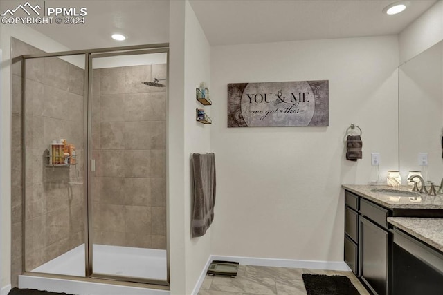 bathroom with walk in shower and vanity