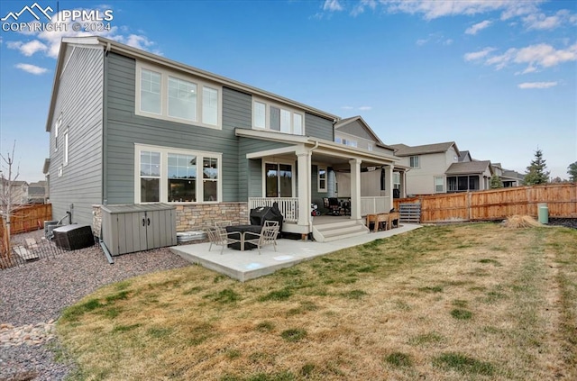 back of house with a yard and a patio area