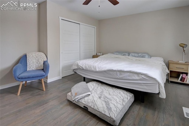 bedroom featuring dark wood-type flooring, a closet, and ceiling fan