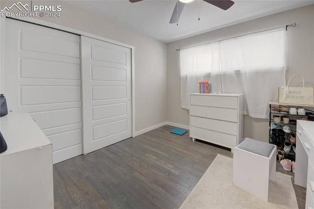 bedroom featuring dark hardwood / wood-style floors, ceiling fan, and a closet