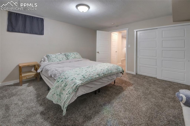 carpeted bedroom featuring a closet and a textured ceiling