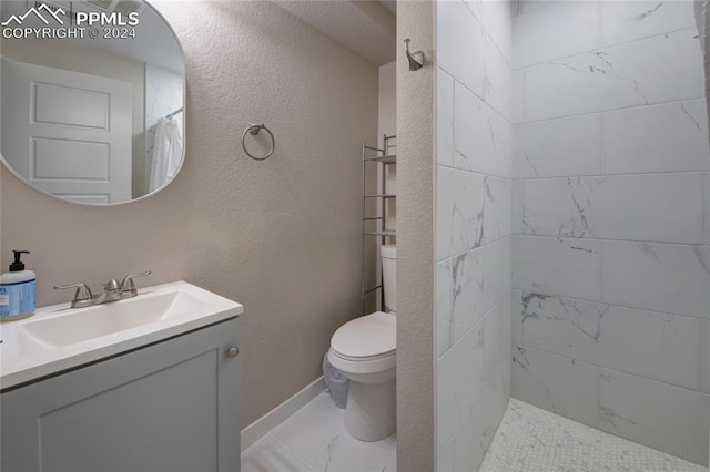 bathroom with toilet, vanity, and a shower with shower curtain