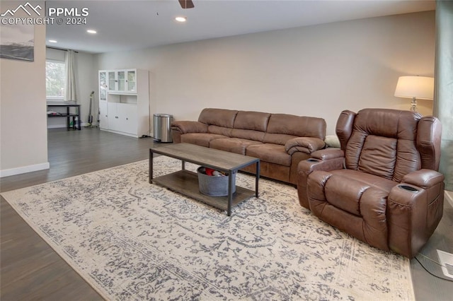 living room featuring dark hardwood / wood-style flooring and ceiling fan