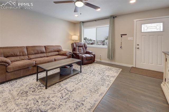 living room with ceiling fan and dark hardwood / wood-style floors