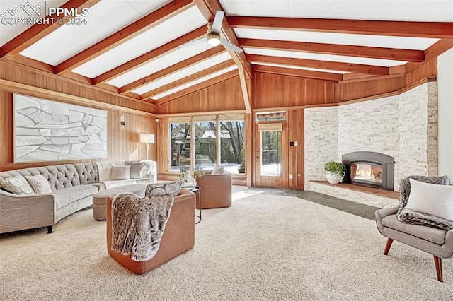 sunroom with a stone fireplace and vaulted ceiling with beams